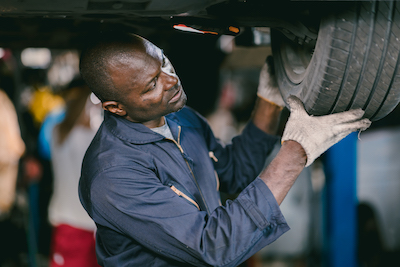 Omaha auto mechanic working on car tires