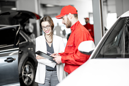 auto mechanic discussing auto repair services with customer
