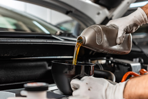 auto mechanic performing a professional oil change service