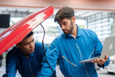 Omaha mechanics inspecting a vehicle during an auto repair service