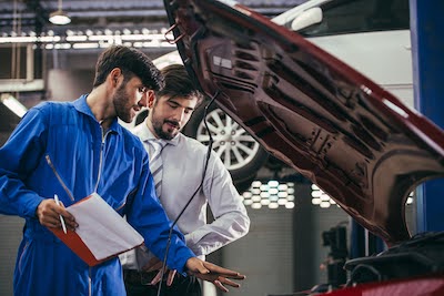 auto mechanic discussing repairs with a customer